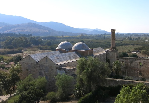 The 14th-century İsa Bey Mosque on the hillside below the Ayasuluk Fortress
