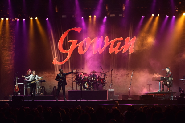 Photo of the stage with the Gowan logo and band performing