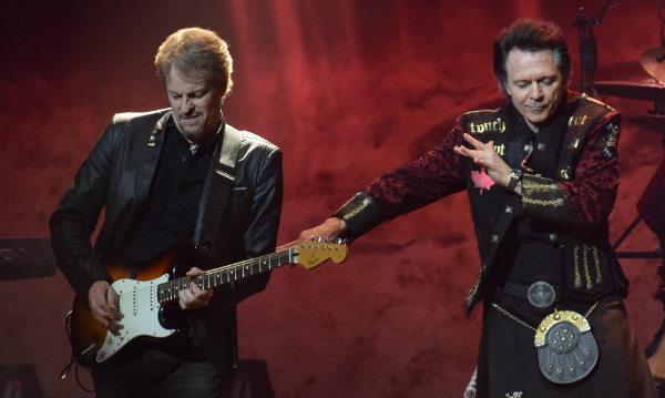 Photo of Bob McAlpine on guitar with Lawrence Gowan dancing beside him