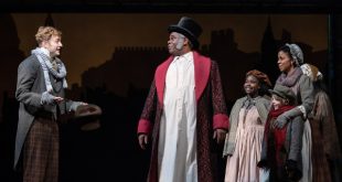 Photo of Gregory Maheu (Bob Cratchit), Craig Wallace (Ebenezer Scrooge), Ariel Russell (Martha Cratchit), Aiden Fuller (Tiny Tim) and Yesenia Iglesias (Mrs. Cratchit) in the Ford’s Theatre 2018 production of “A Christmas Carol” at Ford’s Theatre.
