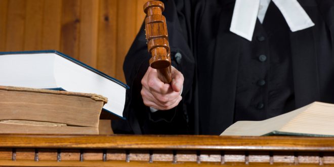 A judge hits the desk or bench with a Gavel during a trial.