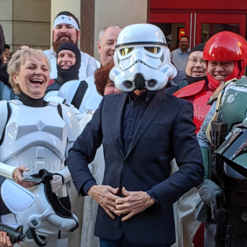 Actor Anthony Daniels wearing a storm trooper helmet