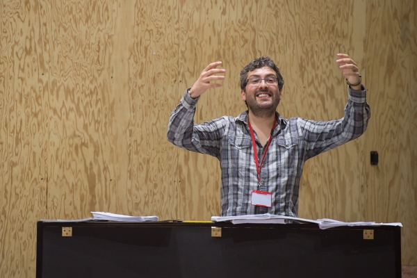 Photo of Tarek Merchant directing the music in a Sweeney Todd rehearsal