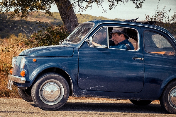 Photo of Ciarán Hinds in a blue FIAT car