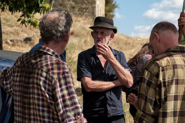 Photo of Stephen Warbeck directing two cast members on the set of The Man in the Hat