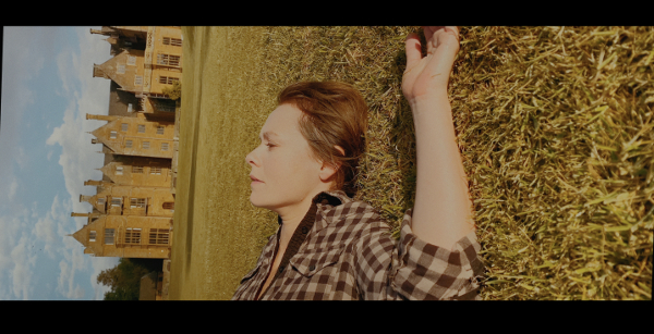 Photo of actress Tori Butler-Hart as Jane lying in a field in the film Infinitum: Subject Unknown