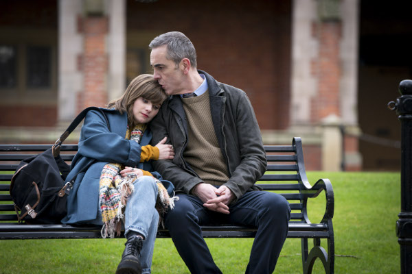 Photo of Lola Petticrew as Izzy Brannick and James Nesbitt as Tom Brannick sitting on a park bench