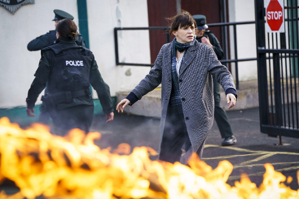 Photo of Charlene McKenna as Niamh McGovern while a car burns