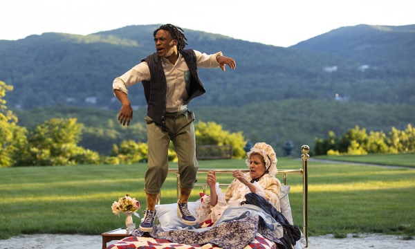 Photo of Tyler Fauntleroy as William jumping on a bed that Nance Williamson as Martha Washington is sitting on