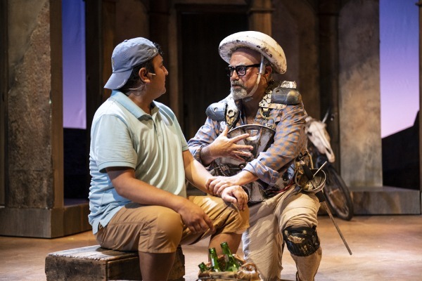Photo of actor Herbert Siguenza kneeling by Ernie González, Jr. 