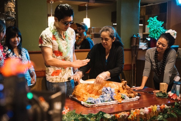 Photo of 'The Girl Who Left Home' cast cutting a pig for a scene