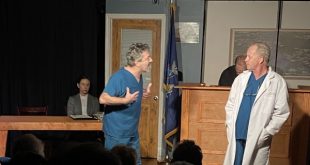 Production photo of a courtroom scene with Rachel Frost, Emanuele Secci, Robert Eigen, and Richard Clodfelter