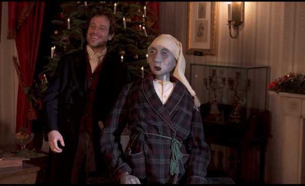 Photo of Dominic Gerrard smiling with a Scrooge puppet