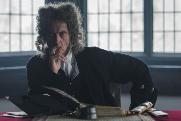 Photo of Peter Capaldi as Dolmen wearing a barrister's wig and sitting at a desk