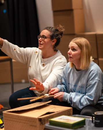 Photo of Helen Eastman pointing to something off-camera as Victoria Jane listens