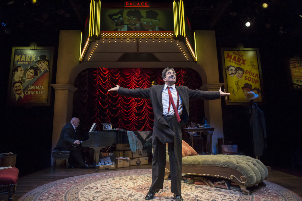 Frank Ferrante with arms outstretched on stage as Groucho Marx