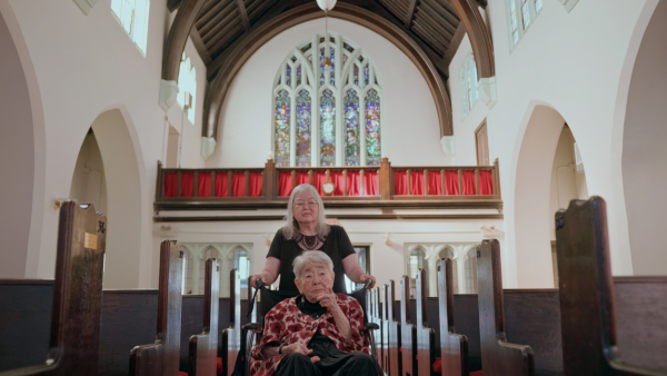 80 Years Later production still of Kiyo and Jean entering First Baptist Church of Chicago