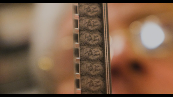 Still from 'Stu's Show' of the 'I Love Lucy' Title Sequence being held to the light