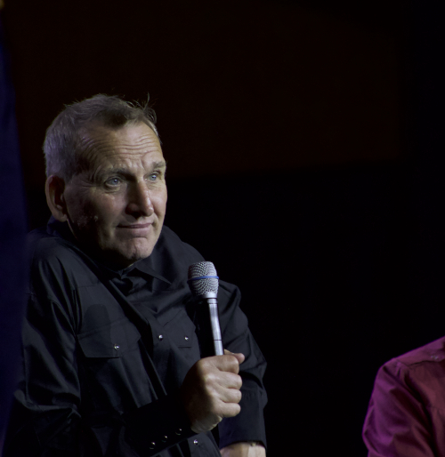 Photo of Christopher Eccleston holding a microphone