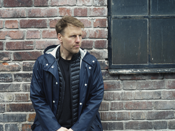 Photo of director and editor Andreas Eidhagen standing by a wall