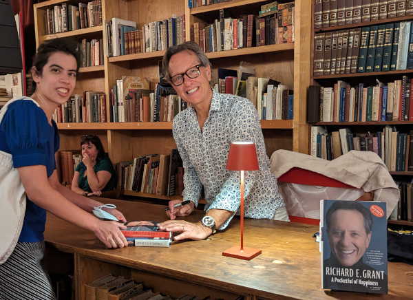 Photo of Richard E. Grant greeting a fan