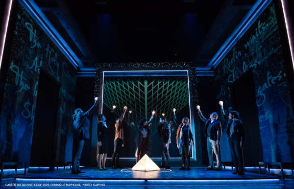 Photo of several The Da Vinci Code cast members standing on stage with their arms raised