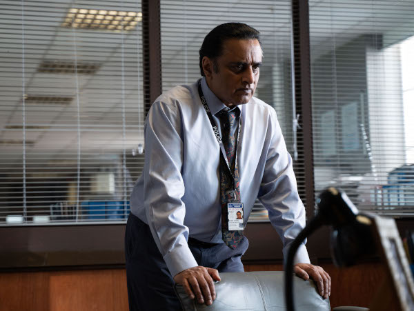 Photo of Sanjeev Bhaskar standing behind a chair