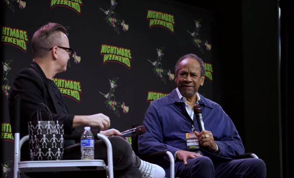 Photo of Tim Reid answering a question from moderator Patty Hawkins