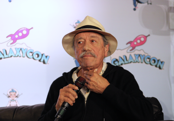Photo of Stand and Deliver star Edward James Olmos holding a microphone