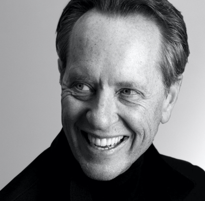 Headshot of Richard E. Grant smiling