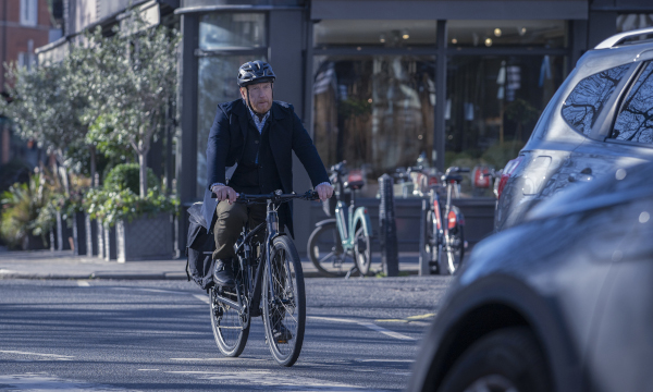 A man bicycling on a London street