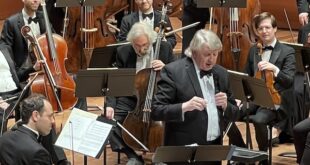 Thomas Crawford demonstrates themes of the music before the concert's official start