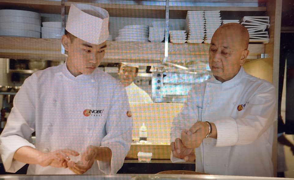 Nobu teaching a future chef in 'Nobu' (courtesy of the film, Tribeca Film Festival)